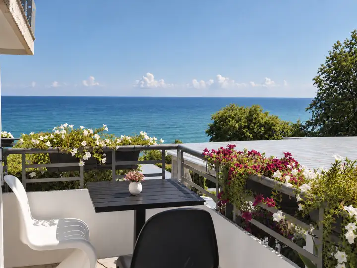 Aegean Spa Suite with indoor jacuzzi, sauna and rooftop jacuzzi, sea view – balcony with flower boxes and open sea view · Panorama Suites & Spa, Stomio