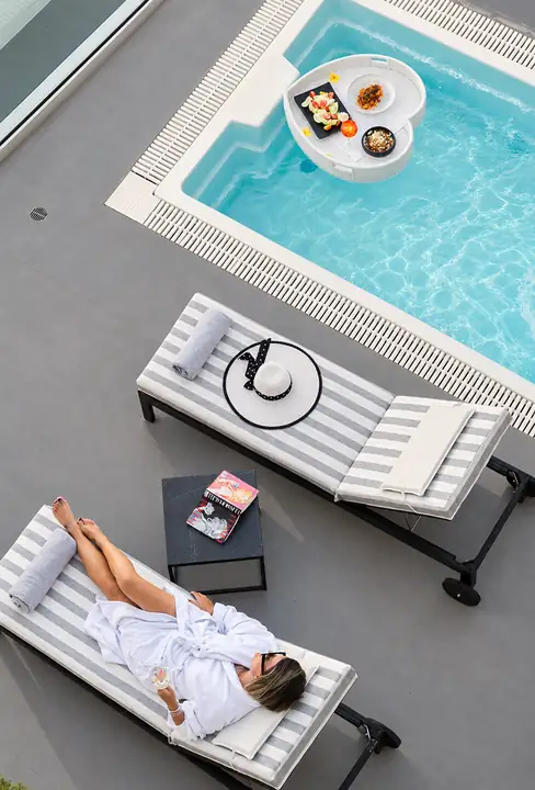Infinity Suite with private heated pool, jacuzzi and sauna, sea view – sun loungers and floating breakfast tray in the private pool · Panorama Suites & Spa, Stomio